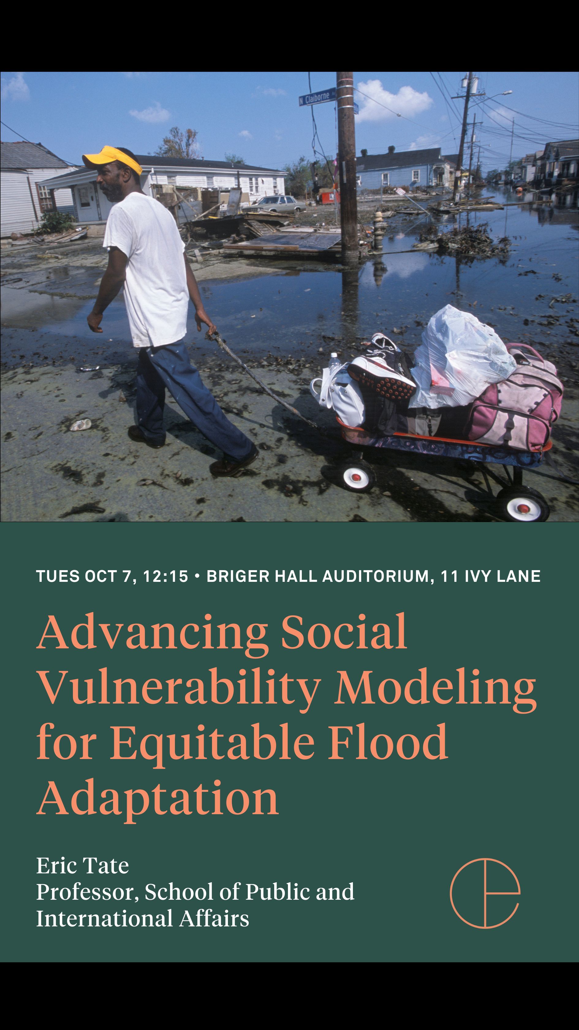 Man pulling cart of belongings with flood water in the background