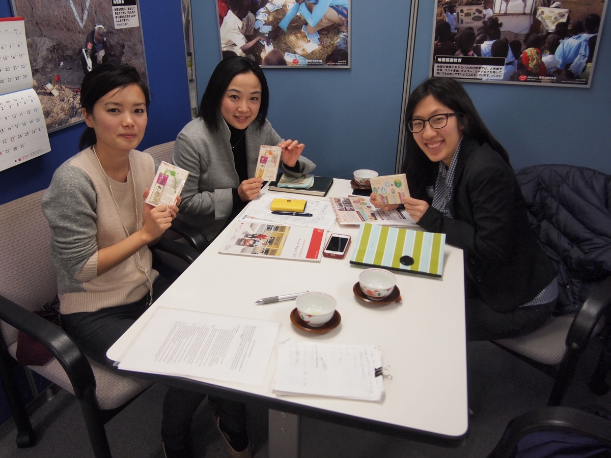 Kim, right, and directors of Japan Association for Aid and Relief hold the chocolate boxes that the organization sells to raise money for relief goods. (Photo credit: Hanna Kim '15)
