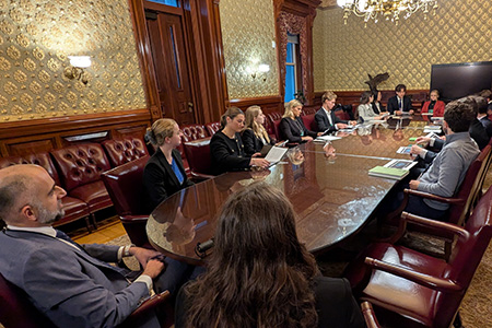 Prof. Ali Nouri and students sitting at an oval table