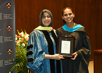 Amina Johari receiving award from Dean Jamal