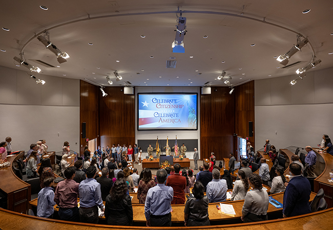 Audience sings the U.S. national anthem.