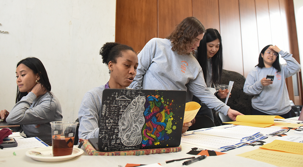 students at table organizing student auction event