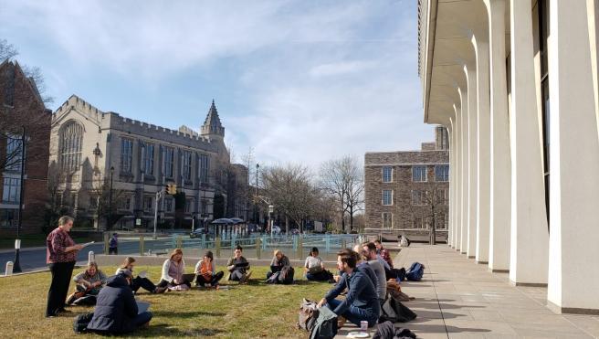 SPIA students sitting socially distanced outside Robertson