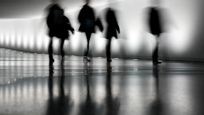 People walk through a tunnel between the Reichstag building and a parliament office building in Berlin. (AP Photo/Markus Schreiber)
