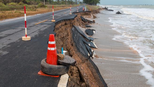 Waves from sea erode road