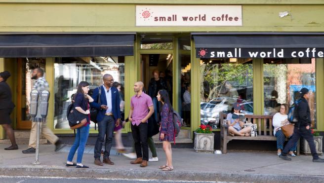 Students standing in front of coffee shop.