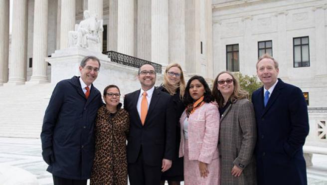 (From left) Princeton President Christopher L. Eisgruber; Princeton Vice President and General Counsel Ramona Romero; Princeton Associate University Counsel Wes Markham; Microsoft Assistant General Counsel Cindy Randall; Princeton Class of 2018 graduate Maria Perales Sanchez; Lindsay Harrison, litigator and partner at Jenner & Block; and Microsoft President and Princeton University Trustee Brad Smith stand in front of the steps of the U.S. Supreme Court in November 2019.