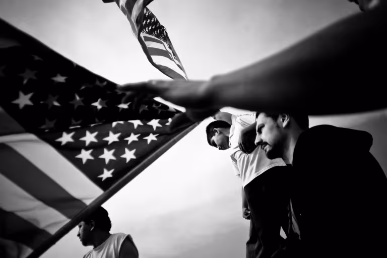 Inherit America exhibit with photo of people holding United States flag