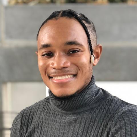 Image of a student wearing a gray sweater.