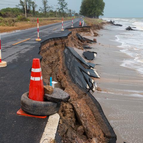 Waves from sea erode road