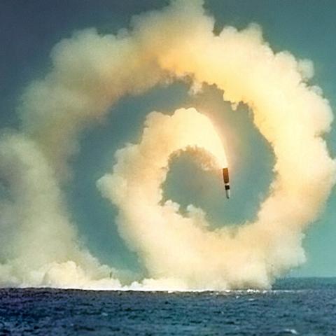 Close Encounters: Facing the Bomb in a New Nuclear Age exhibit, photo of missile in a spiral heading toward ocean water