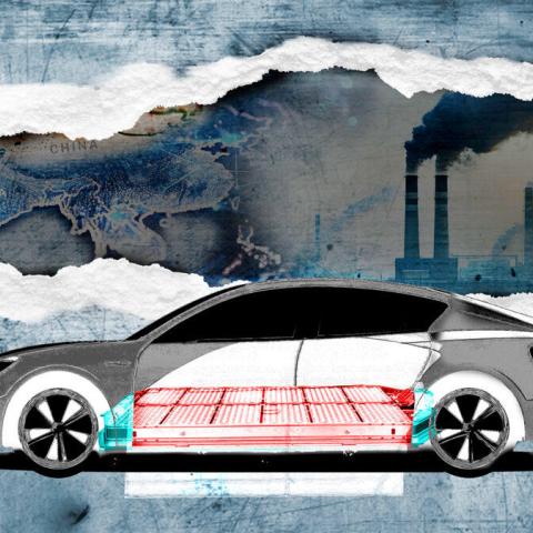 gray electric car with smokestacks in the background