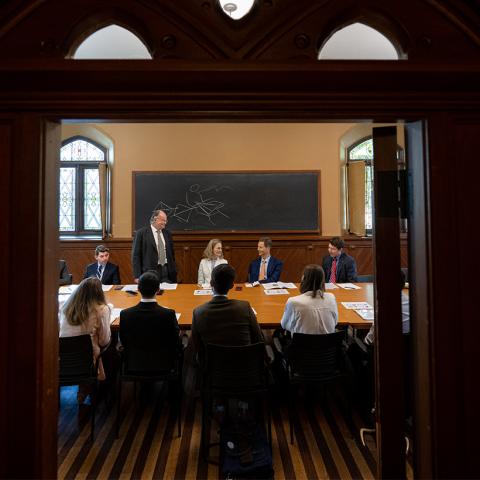 Individuals sitting around a table in discussion