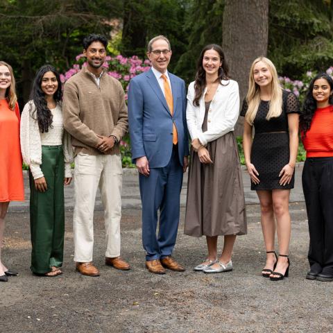 President Christopher L. Eisgruber (center) stands with (from left to right) Luke Miller, Genevieve Shutt, Aaliska Sapkota, Jaisnav Rajesh, Caroline Kane, Alyssa Lloyd, Tharuka Hikkaduwa Gamage and Jaden Stewart. Photo bySameer A. Khan/Fotobuddy