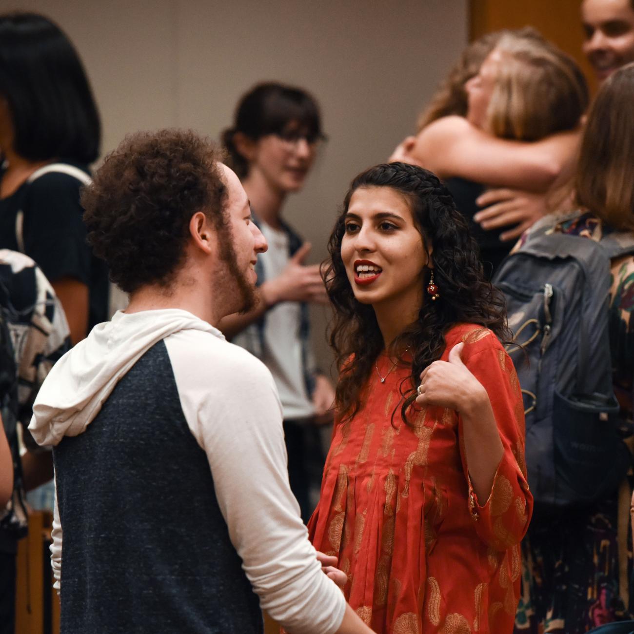 Woman talking to a friend in a crowd of students