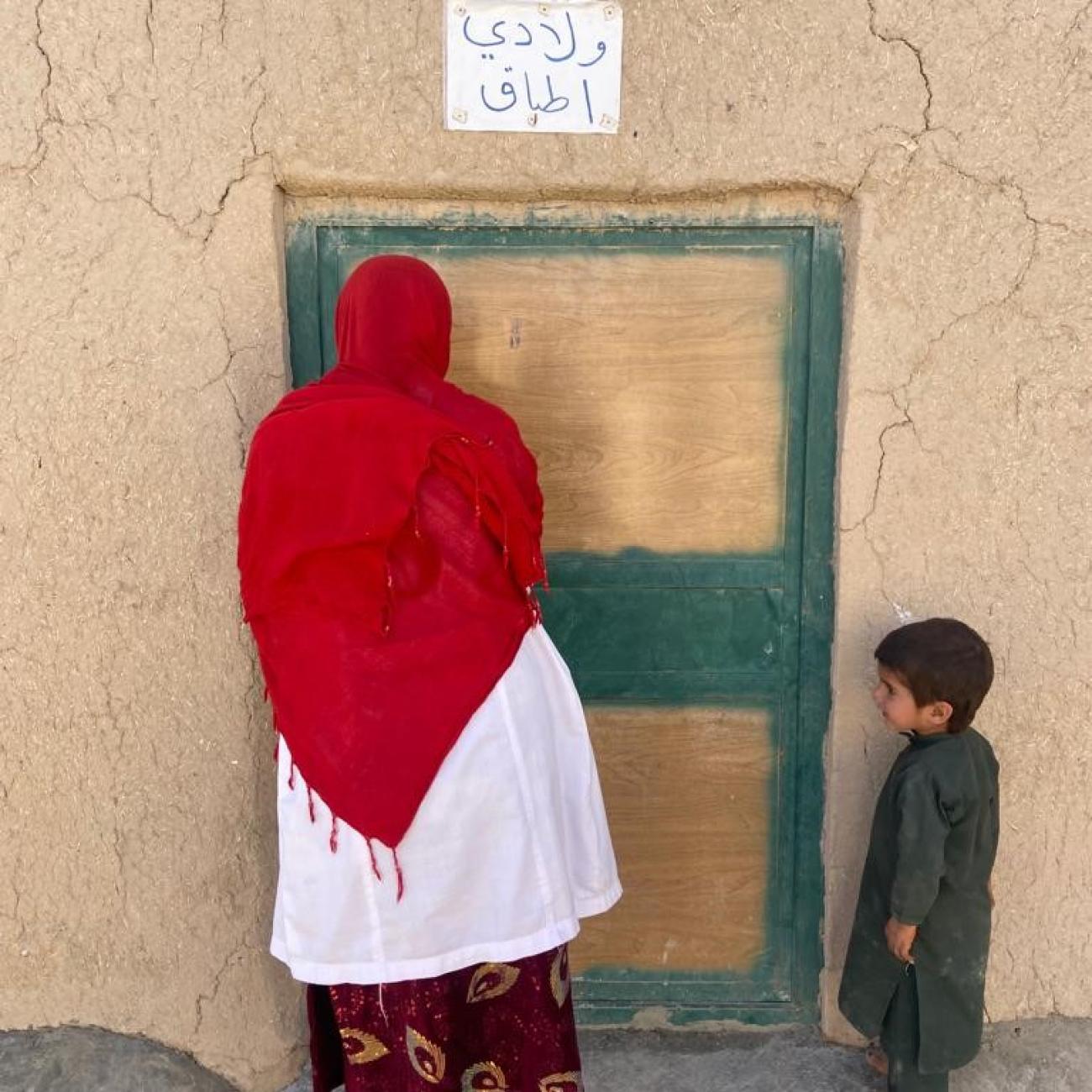 woman and child standing in front of door