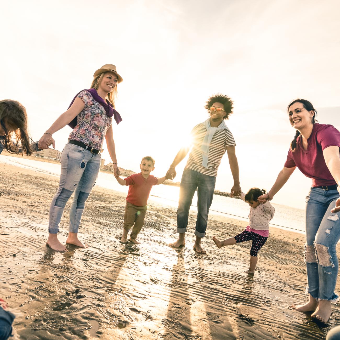adults and children holding hands in a circle