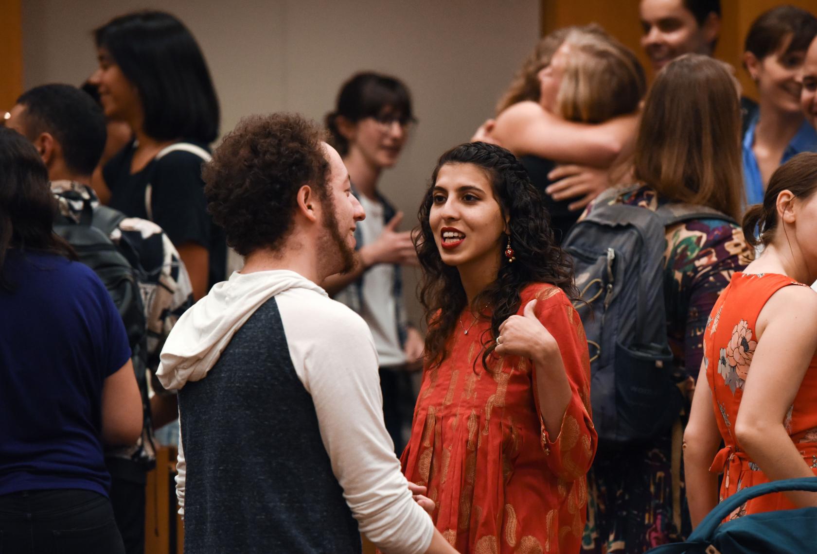 Woman talking to a friend in a crowd of students