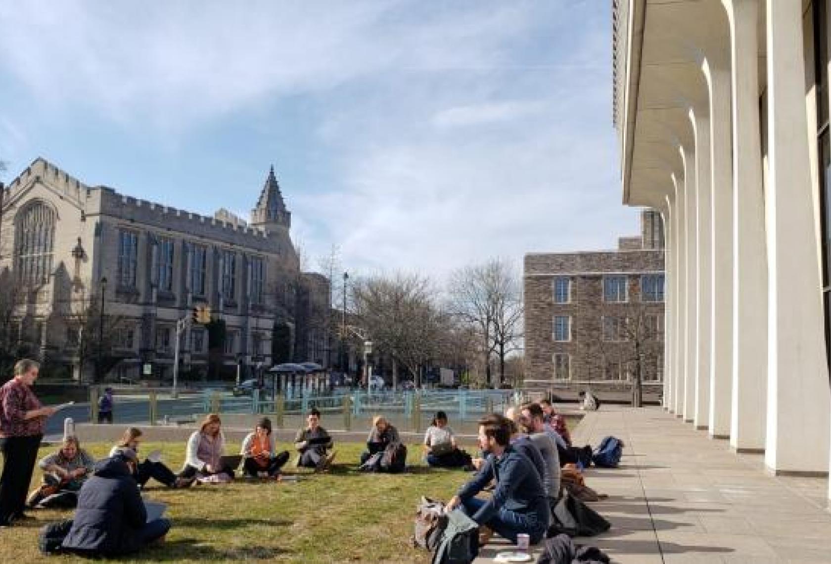 SPIA students sitting socially distanced outside Robertson