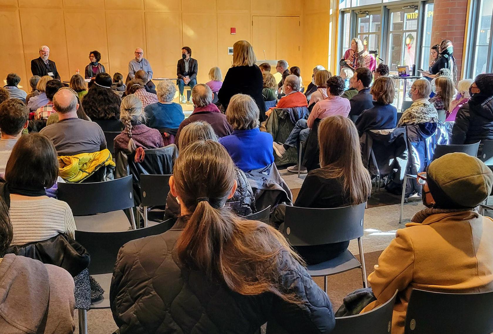 Public housing forum event including panelists and participants
