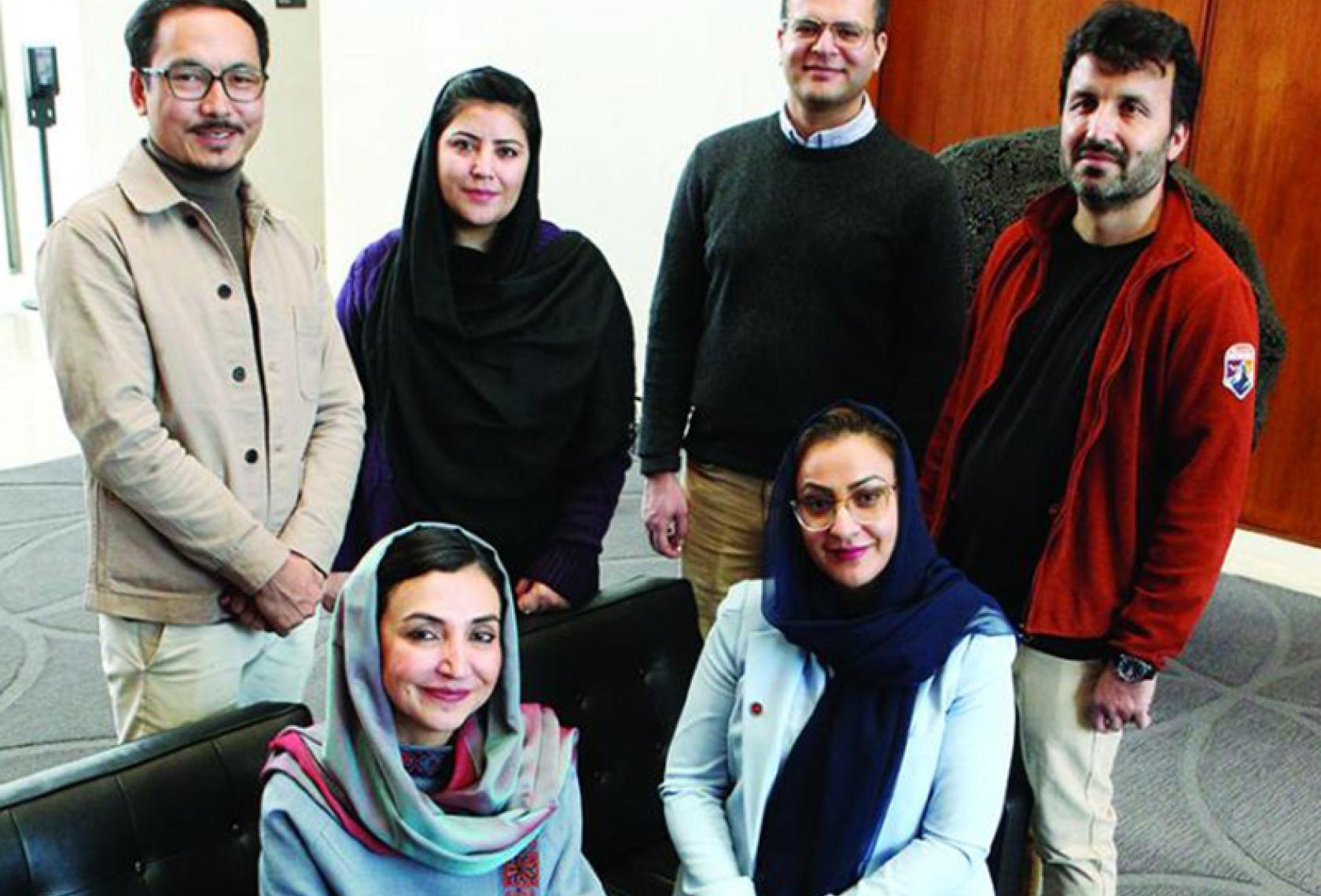 Members of the Afghanistan Policy Lab include, back row from left, Lutf Ali Sultani, Storai Tapesh, Muhammad Idrees Ghairat, and Gran Hewad; and front row from left, Ambassador Adela Raz and Naheed Farid. Photo: Frank Wojciechowski.