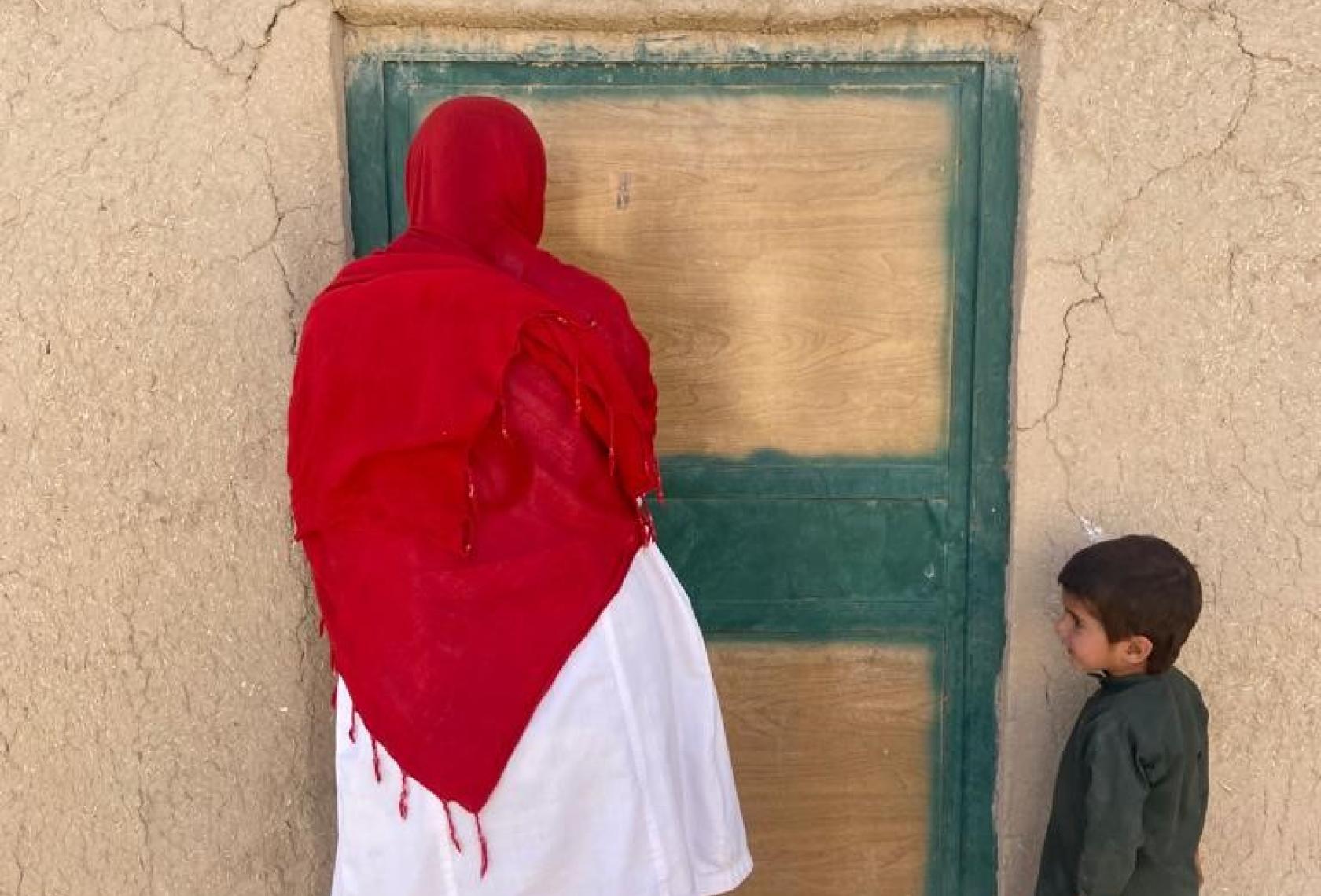 woman and child standing in front of door