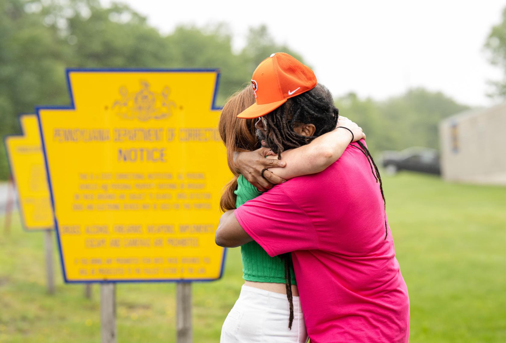 Muti Ajamu-Osagboro hugs a student from the Making an Exoneree course after his release from prison. 