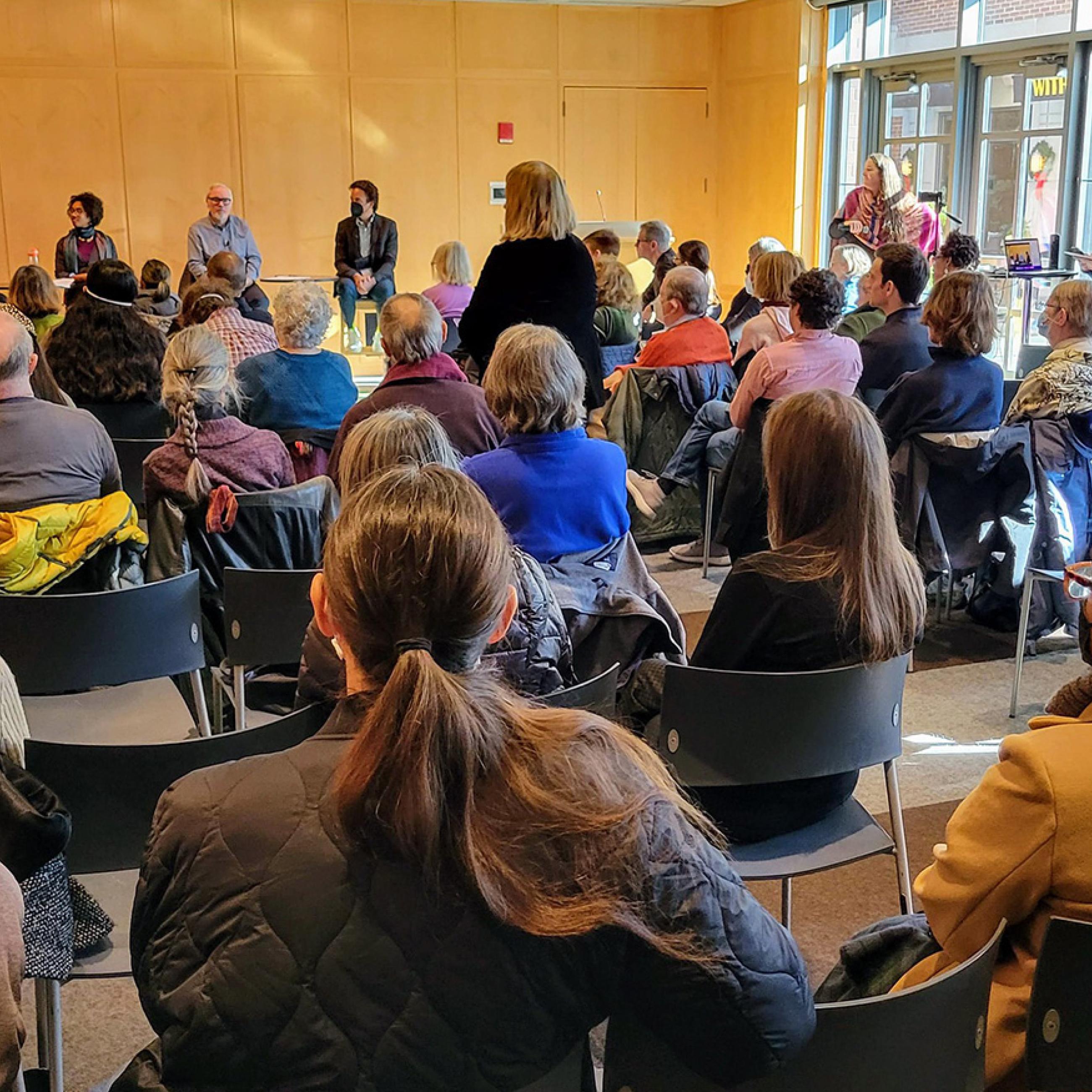 Public housing forum event including panelists and participants