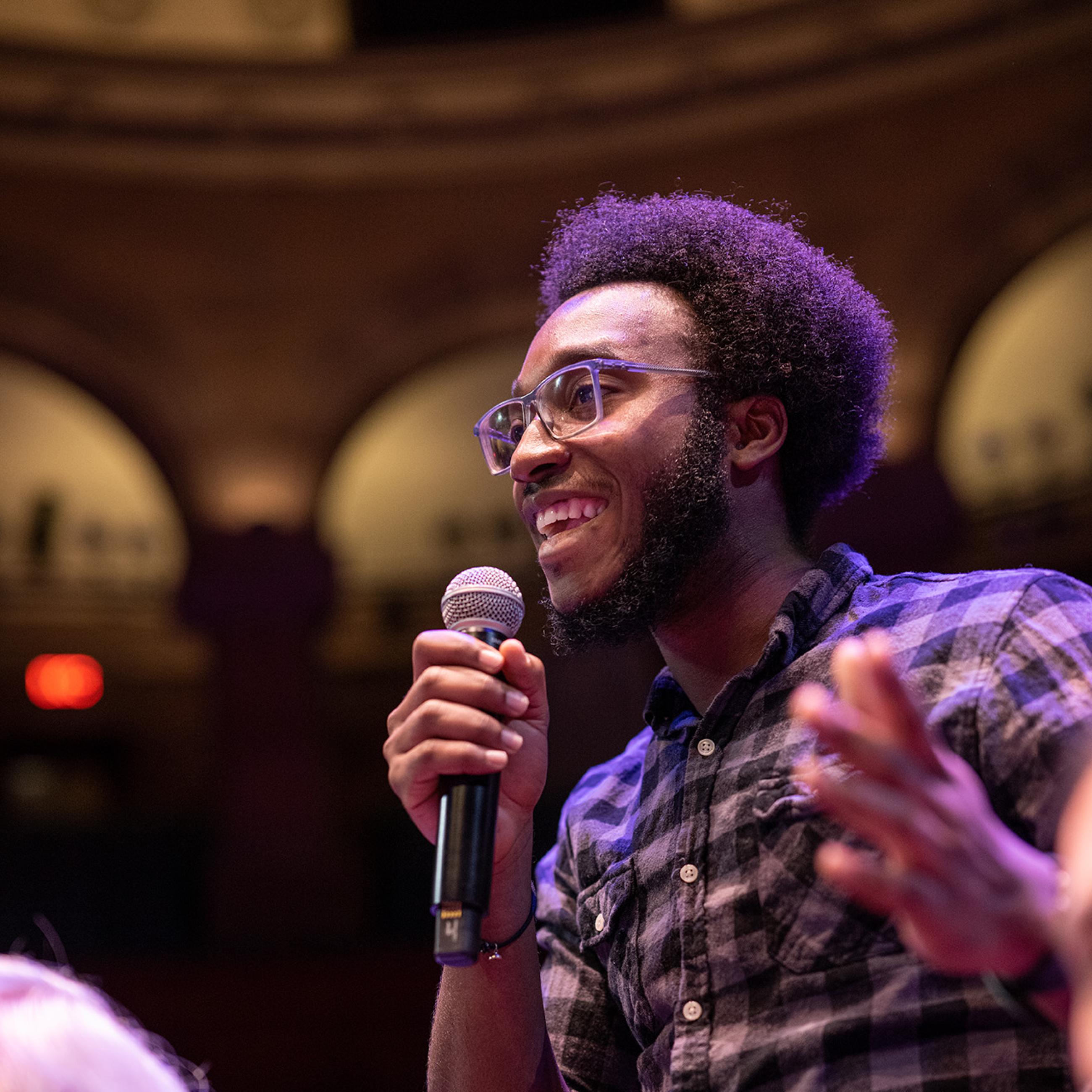 Event attendee with microphone during Q&A