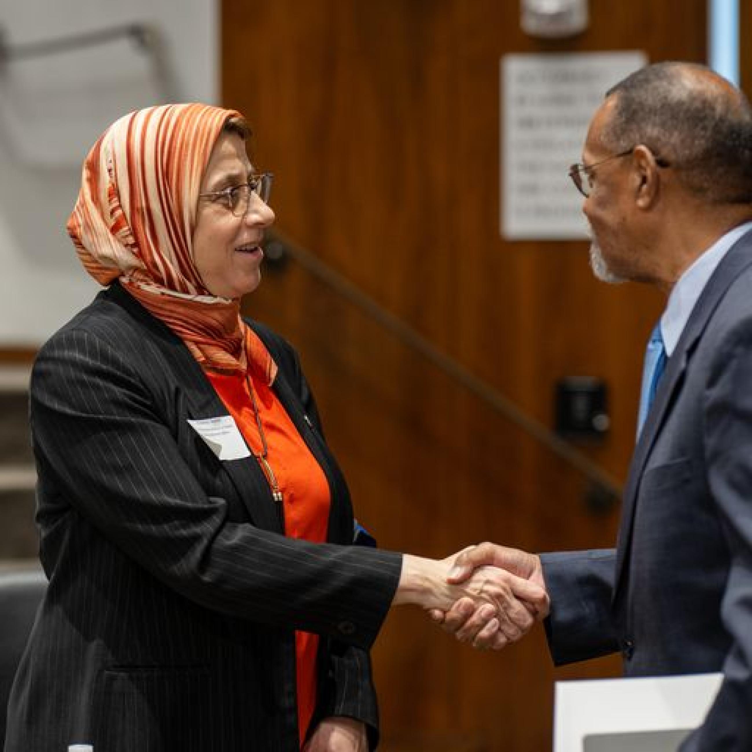 Dean Amaney Jamal greets speaker Richard Roper