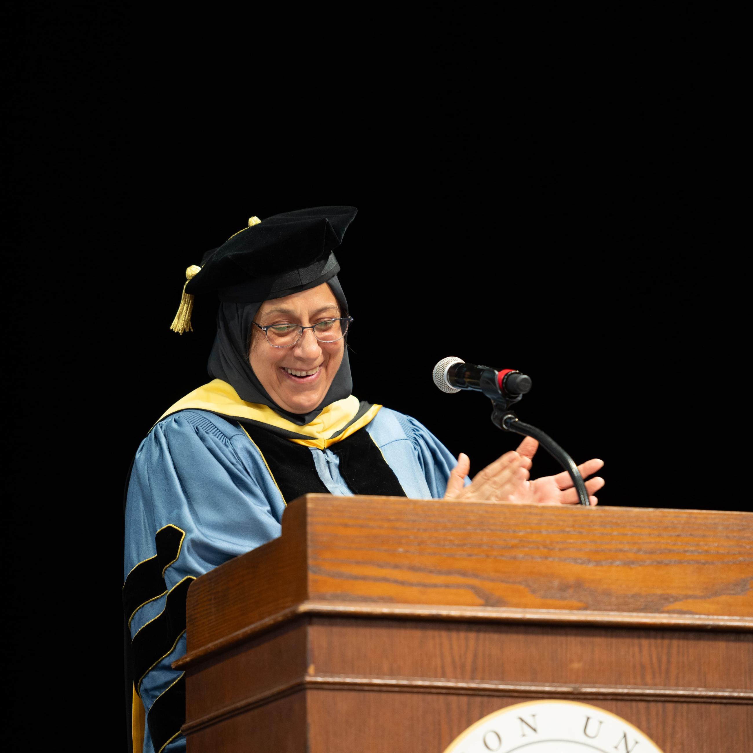 2024 SPIA Hooding Ceremony with Dean Jamal at podium
