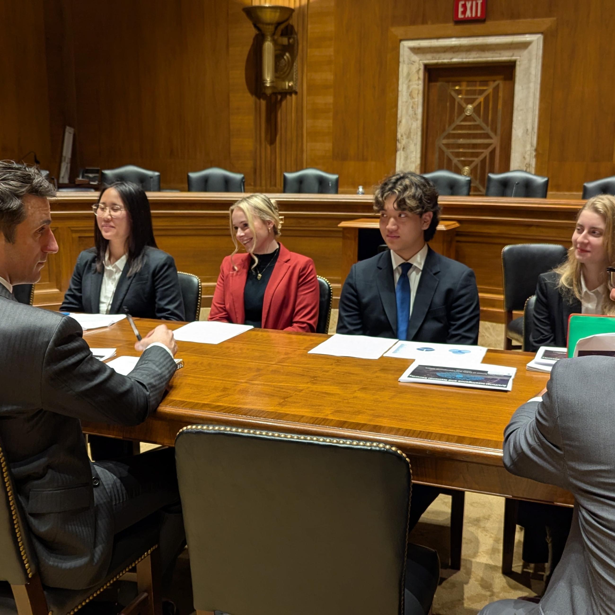 AI Task Force-students sitting at oval table