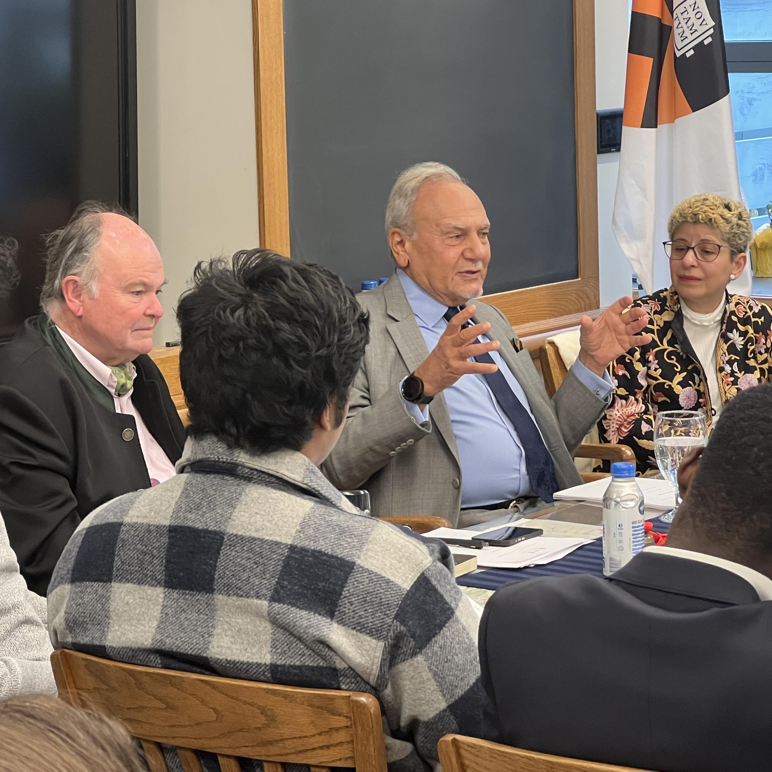 Individuals in discussion sitting around a table at a LISD geopolitical brunch