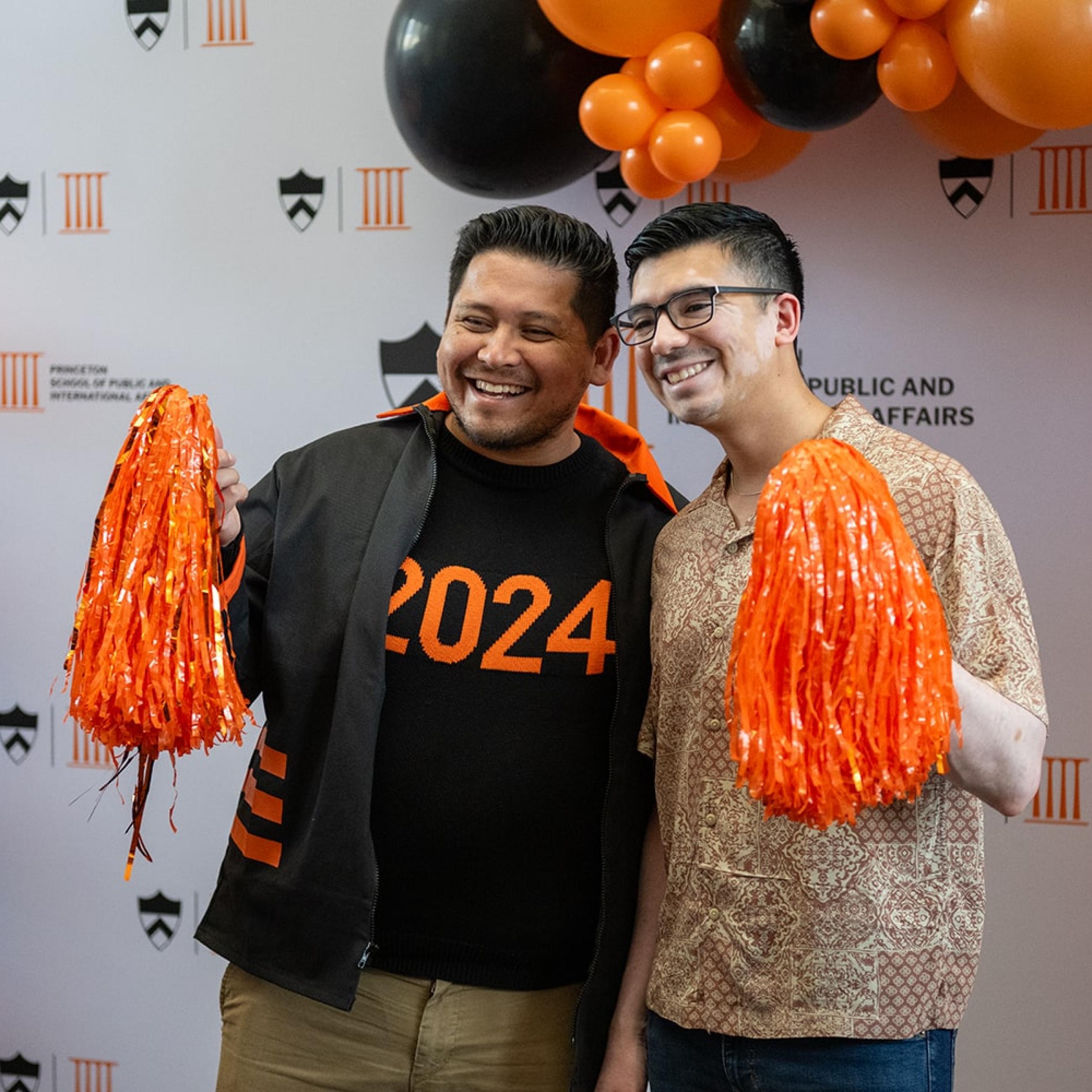 SPIA alum posing for photo booth in Dodd's atrium