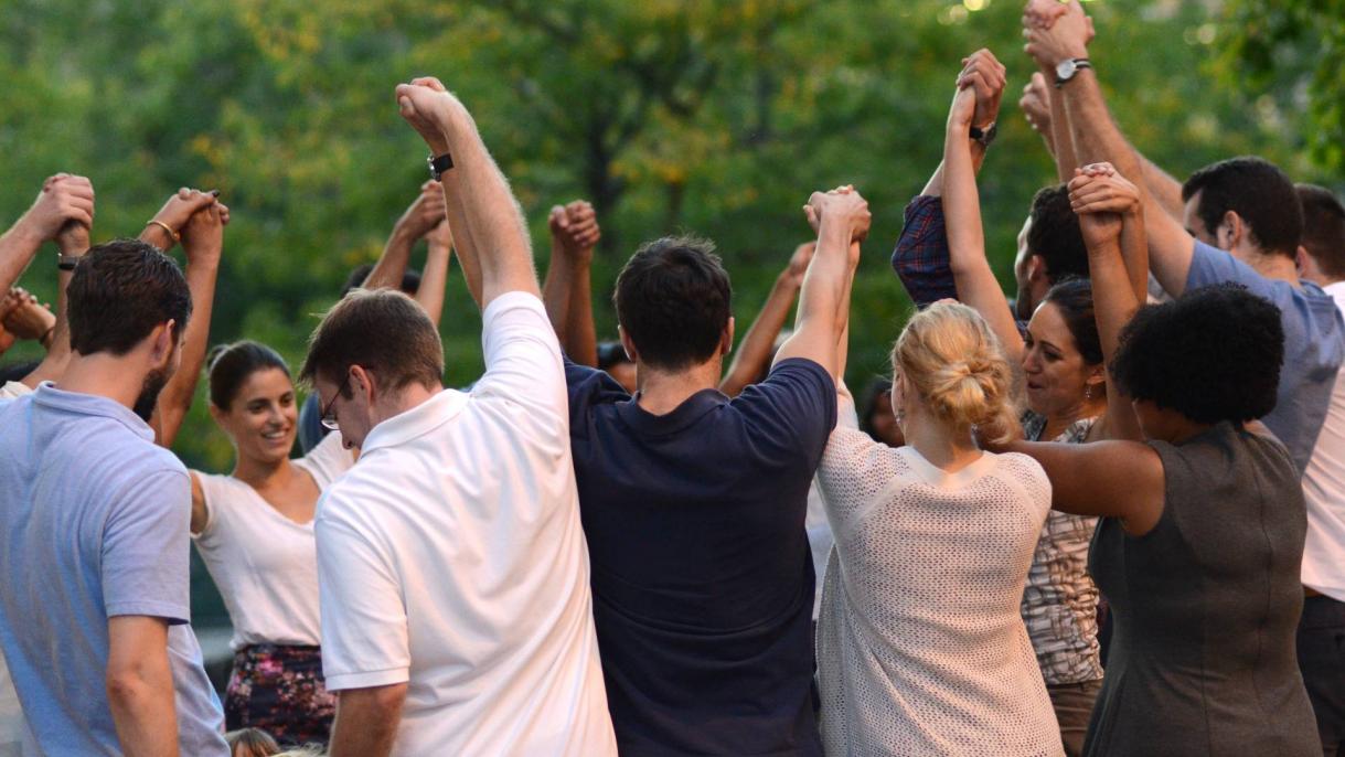group of students holding hands