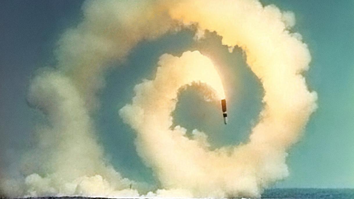 Close Encounters: Facing the Bomb in a New Nuclear Age exhibit, photo of missile in a spiral heading toward ocean water