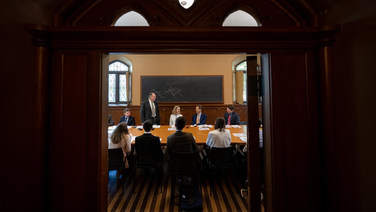 Individuals sitting around a table in discussion