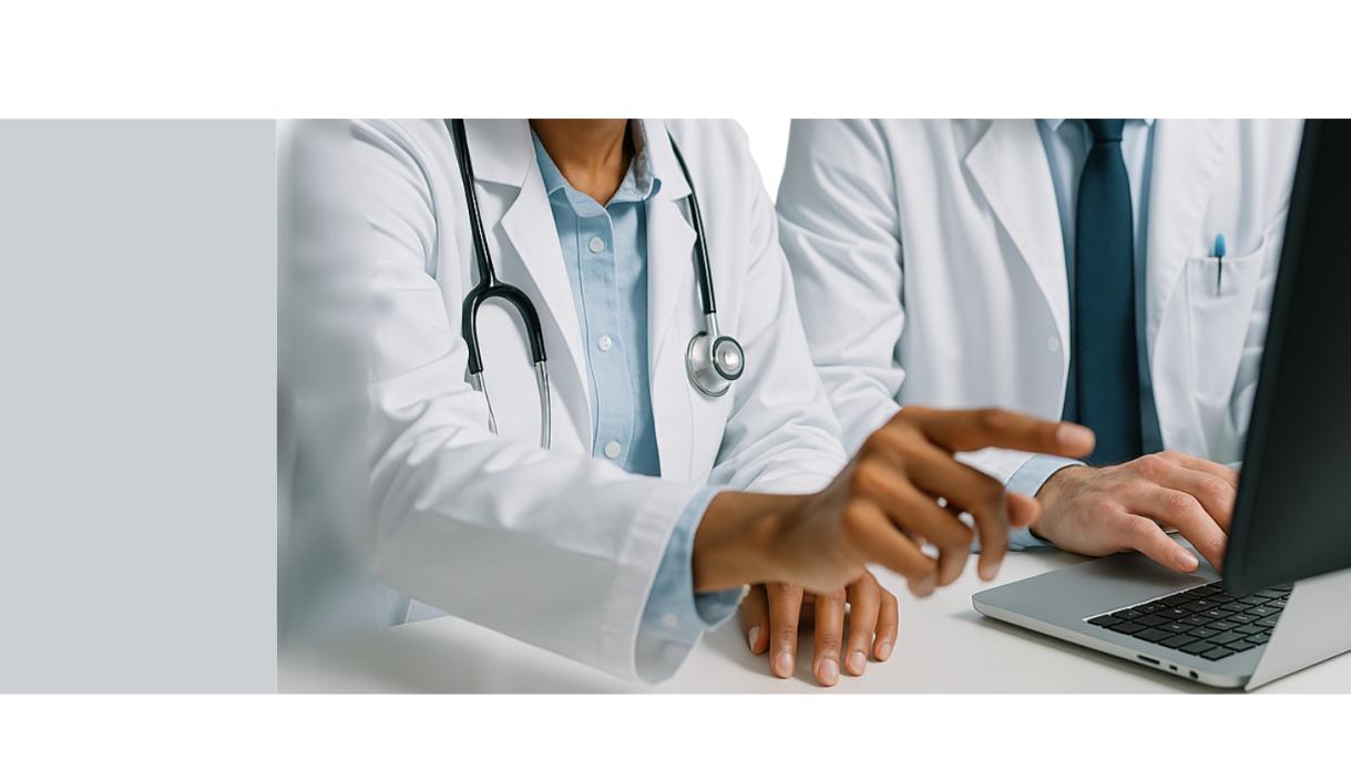 Two physicians conferring over computer