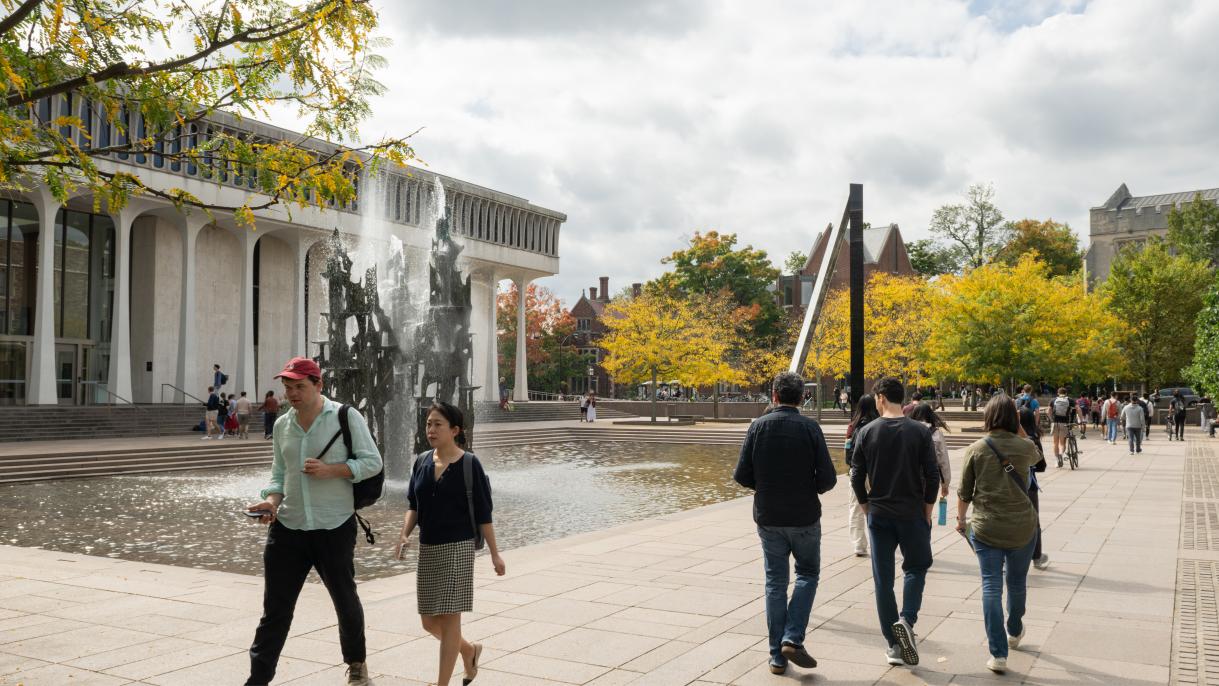 Students walking near fountain at Scudder Plaza